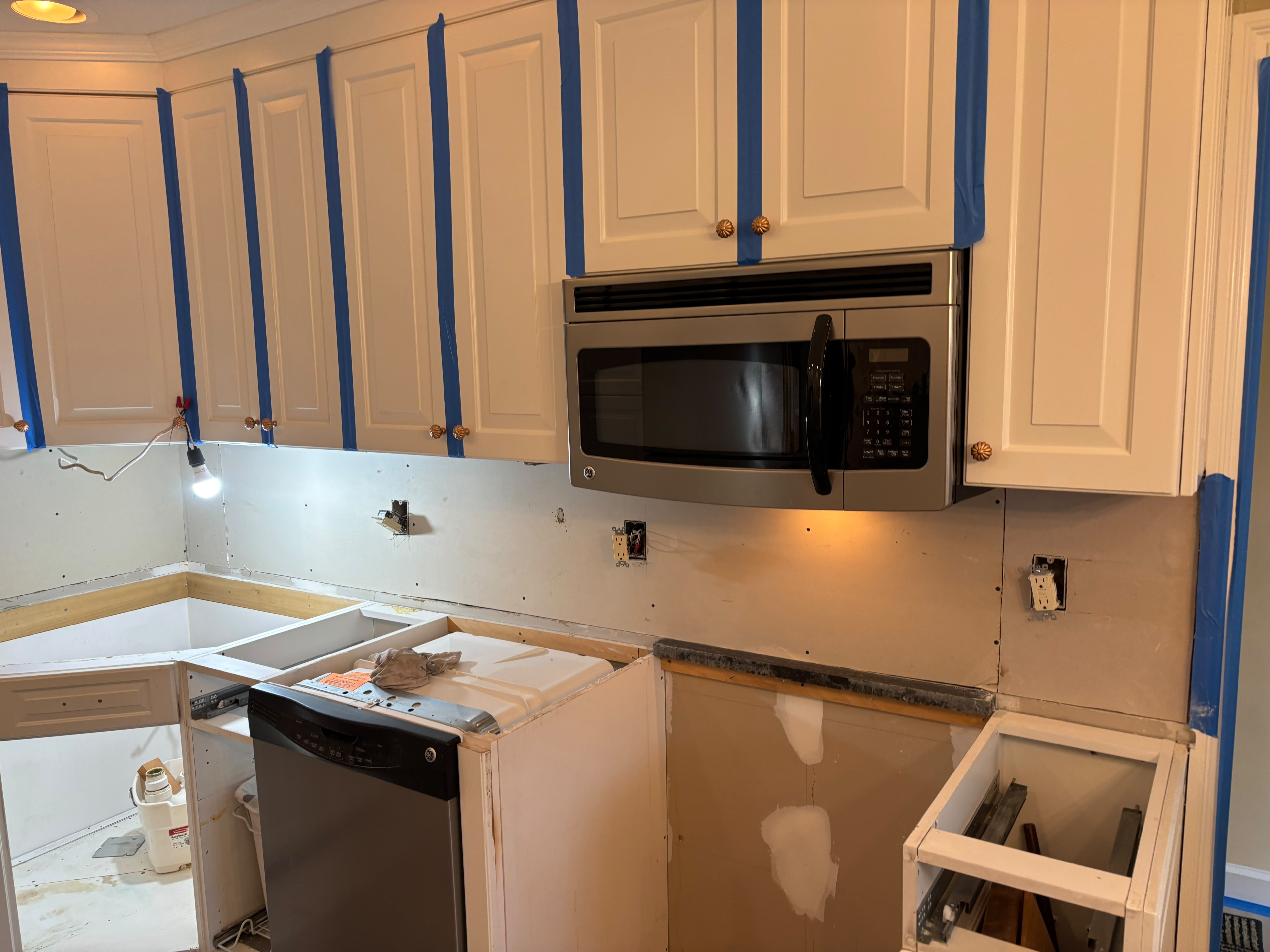 Kitchen cabinetry and microwave installation in progress, from the Anastos Contractors project gallery