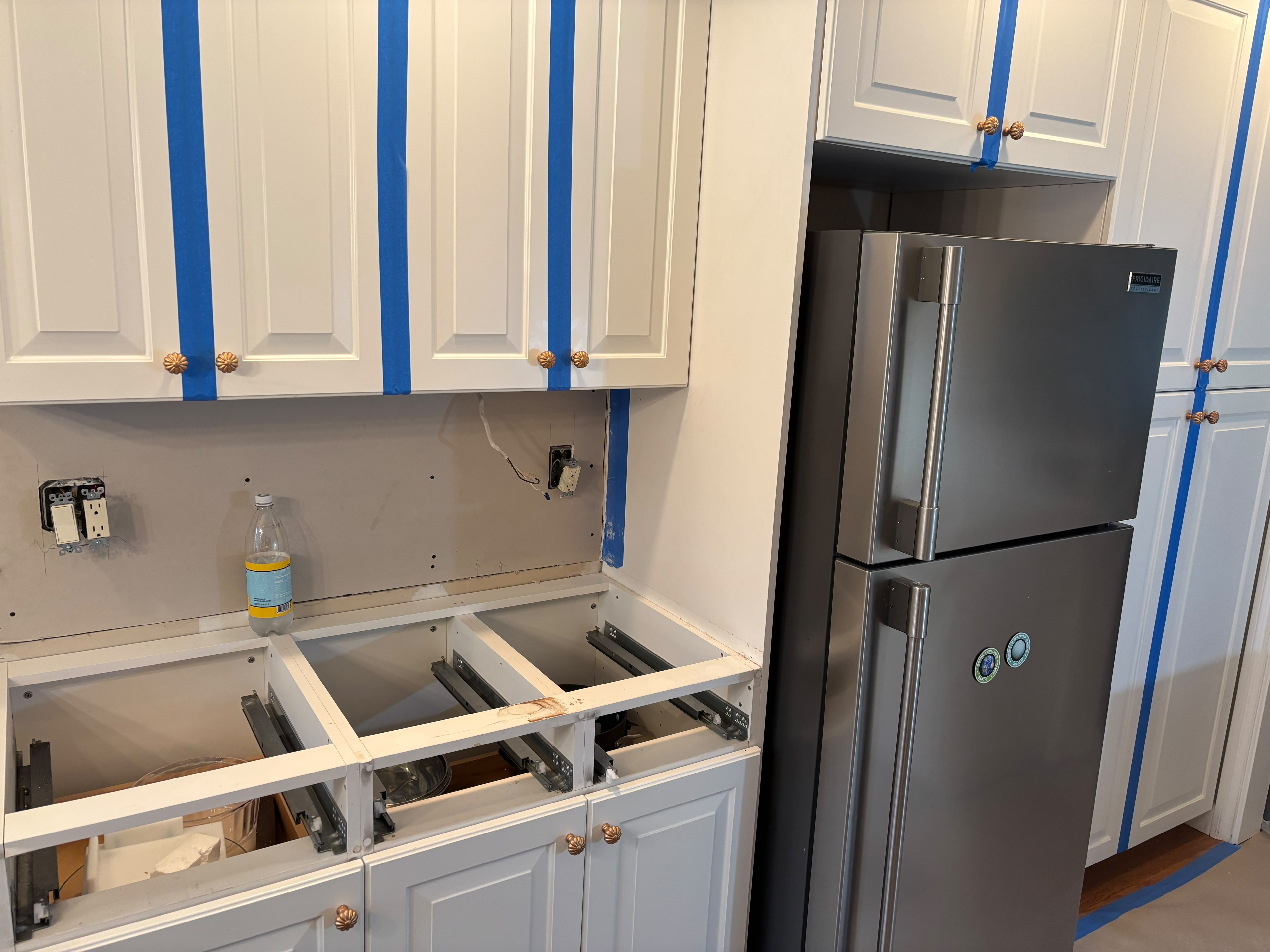 Kitchen sink, cabinetry and refrigerator installation in progress, from the Anastos Contractors project gallery